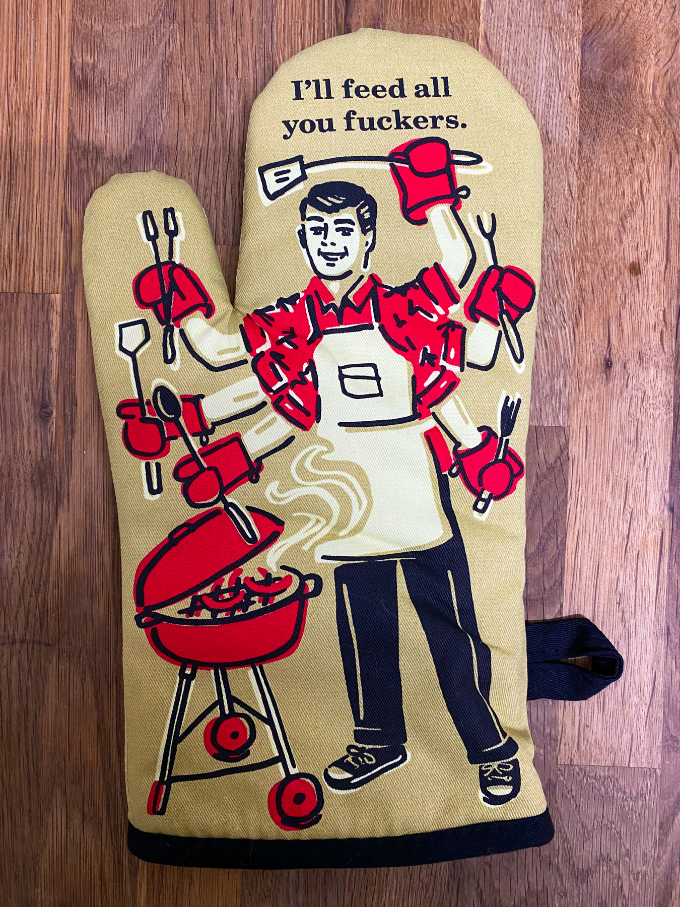 Oven glove with picture of a man cooking and the text - I’ll feed all you fuckers
